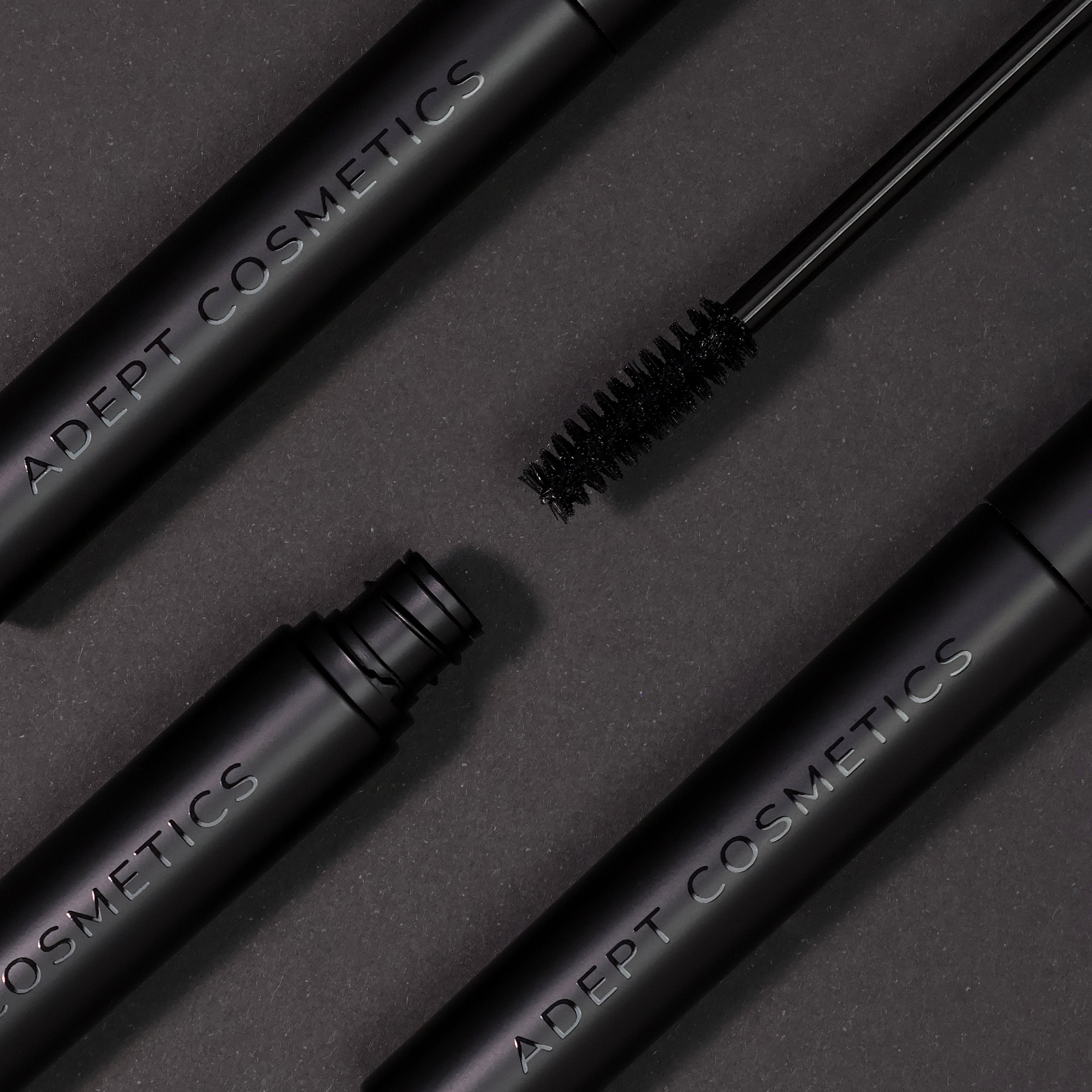 Adept Cosmetics makeup brushes on a dark background